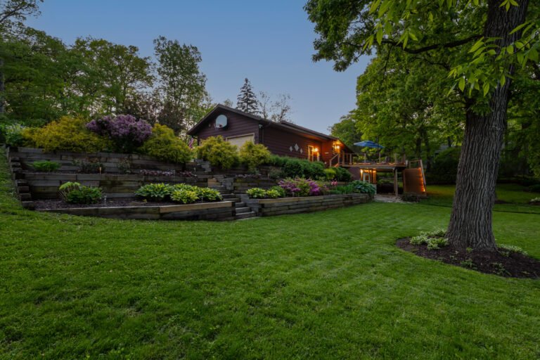 Twilight photo of a home and landscaping
